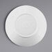 A white Elite Global Solutions round plate with a white rim.