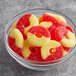 A bowl of red and yellow Albanese Strawberry Banana Gummi Rings.