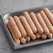 A tray of frozen Impossible Foods plant-based vegan beef hot dogs.