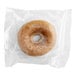 An individually wrapped Southern Roots pumpkin spice cake donut in a plastic wrapper.