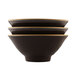 Three black Elite Global Solutions Pebble Creek Tapenade bowls with gold trim stacked on a white surface.