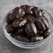 A bowl of Albanese dark chocolate covered pecans.