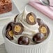 A bowl of ice cream with Albanese dark chocolate malt balls.