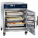 Alto-Shaam Undercounter Cook and Hold Oven with trays of food in it.