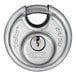 A close up of a stainless steel ABUS padlock with a key in it.