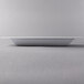 A white rectangular Libbey Slenda porcelain bowl on a gray surface.