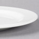 A close up of a white Libbey porcelain plate with a medium rim.