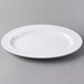 A Libbey white porcelain platter with a wide rim on a gray surface.