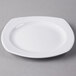 A white Libbey square porcelain plate on a gray surface.