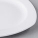 A close up of a Libbey white porcelain plate with a small rim.