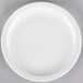 A Libbey white porcelain plate with a narrow rim on a gray surface.