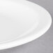 A close up of a Libbey white porcelain plate with a narrow rim.