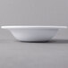 A close up of a Libbey white porcelain fruit bowl.