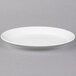 A white Libbey oval porcelain platter on a gray surface.