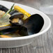 A white Libbey oval porcelain platter with mussels and lemon.