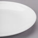 A close up of a Libbey white porcelain coupe plate with a round rim.