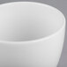 A close up of a white Libbey porcelain bouillon cup with a small handle.