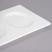 A white rectangular porcelain tray with three round wells.