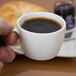 A person holding a Libbey Slenda low espresso cup of coffee.