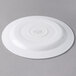 A Libbey Royal Rideau white porcelain plate with a medium rim on a gray surface.