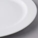 A close up of a Libbey white porcelain plate with a white rim.