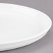 A close up of a Libbey white porcelain tray with a rim.