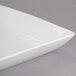 A white Libbey square coupe plate with a flat edge.