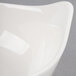 A close up of a Libbey Royal Rideau white porcelain bowl with a curved edge.