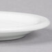 A close up of a Libbey white porcelain plate with a narrow rim.