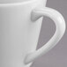 A close up of a Libbey Royal Rideau white porcelain tea cup with a handle.