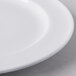 A close up of a Libbey white porcelain plate with a white rim.