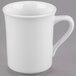 A close-up of a Libbey white porcelain mug with a handle.