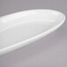 A white Libbey oval porcelain serving tray with curved edges.