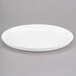 A Libbey white porcelain tray with a rim on a gray surface.