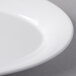 A close up of a Libbey white porcelain platter with a curved edge.