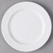 A Libbey white porcelain plate with round rims on a gray surface.
