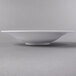 A Libbey white porcelain bowl on a gray surface.