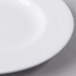 A close up of a Libbey white porcelain plate with a small amount of food on it.