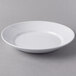 A Libbey white porcelain entree and pasta bowl with a rim on a gray surface.