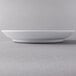 A Libbey Royal Rideau white porcelain entree and pasta bowl on a gray surface.