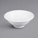 A white Elite Global Solutions Pebble Creek bowl with a white rim on a gray surface.