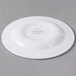 A white Libbey porcelain plate with a circular design on the rim.