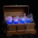 A wooden chest with blue liquid and smoke in two glasses.