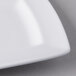 A close up of a Libbey white rectangular plate with a square edge.