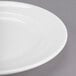 A close up of a Libbey white porcelain plate with a wide rim.