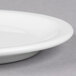 A close up of a Libbey white porcelain plate with a narrow rim.