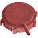 A red plastic pressure switch cover with a circular hole.