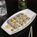 A plate of sushi on a white Libbey Slenda rectangular serving tray.