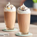 Two glasses of Cappuccine Kona Mocha Frappes with whipped cream on top.