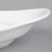 A close up of a Libbey white porcelain handle platter with curved edges.